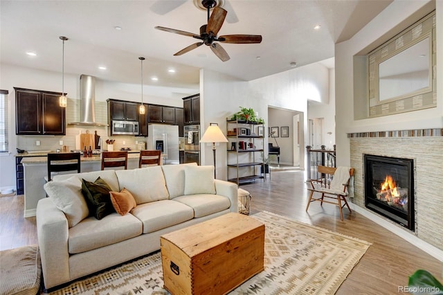 living room featuring light wood-type flooring and ceiling fan