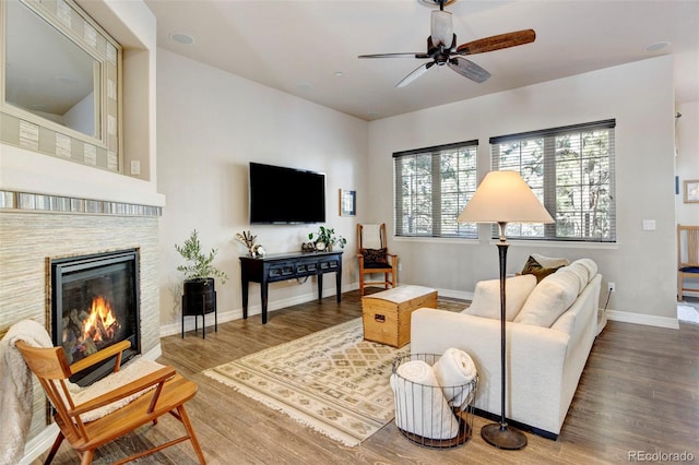 living room with hardwood / wood-style flooring and ceiling fan