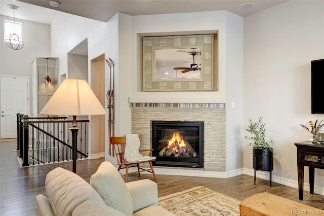 living room featuring wood-type flooring and ceiling fan