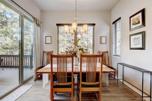 dining room featuring a chandelier and light wood-type flooring