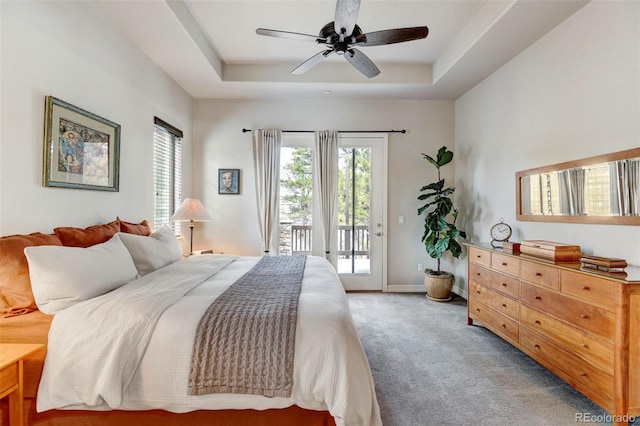 bedroom with a raised ceiling, ceiling fan, access to exterior, and carpet floors