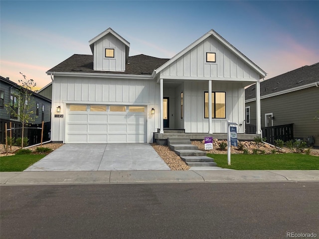 view of front of property with a porch and a garage