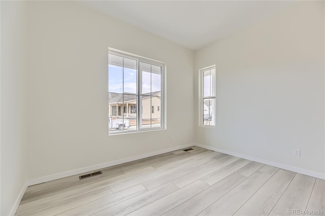 empty room with light hardwood / wood-style flooring