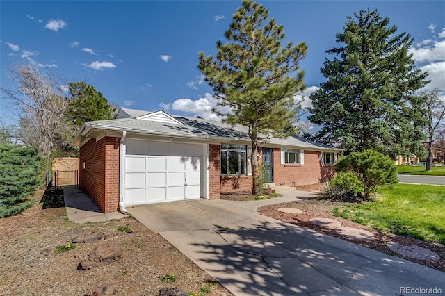 ranch-style house featuring an attached garage, brick siding, driveway, and fence