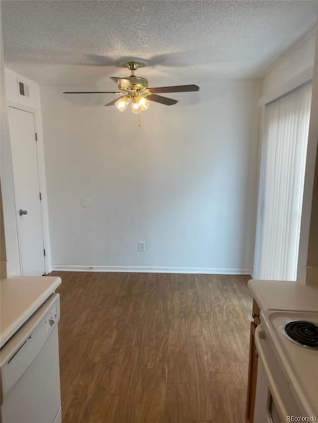 interior space with a textured ceiling, ceiling fan, and dark wood-type flooring