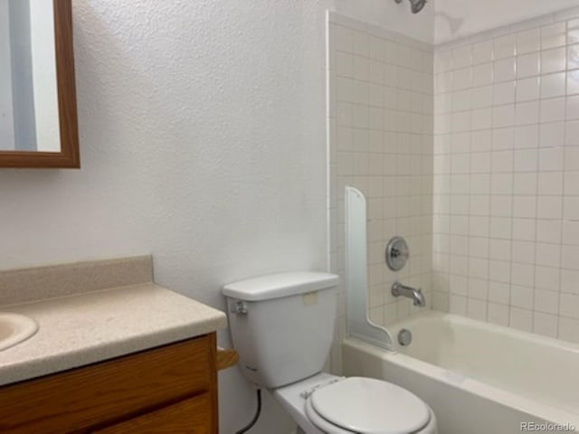 full bathroom featuring vanity, toilet, and tiled shower / bath combo