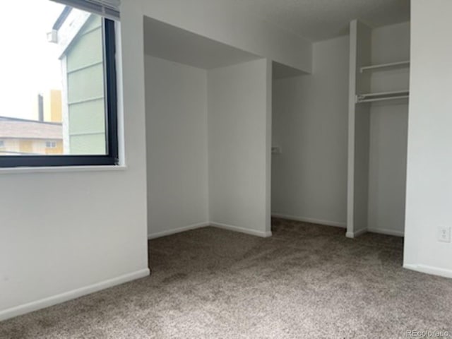 unfurnished bedroom featuring a closet and carpet