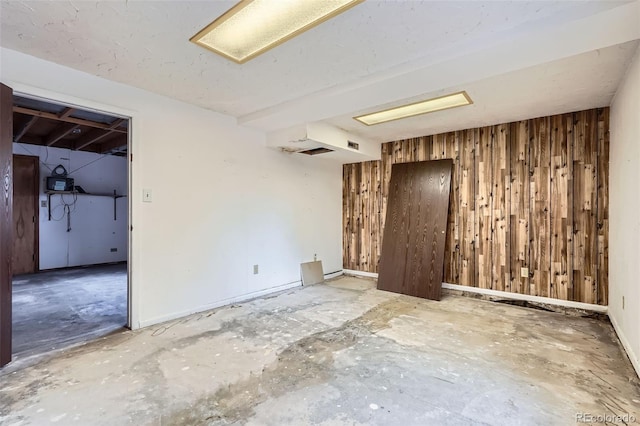 spare room with wood walls
