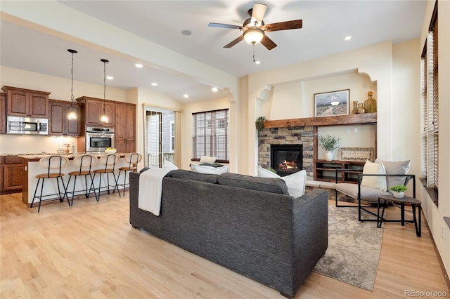 5723 S Union Ct, Littleton, CO 80127 - living area featuring light wood-style floors, a stone fireplace, a ceiling fan, and recessed lighting