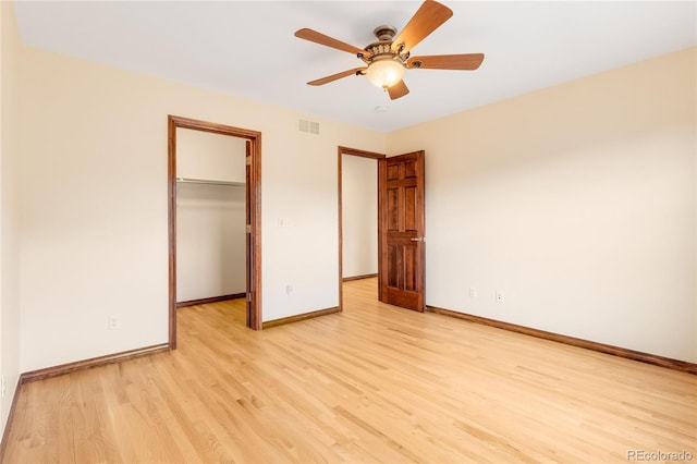 5723 S Union Ct, Littleton, CO 80127 - unfurnished bedroom featuring light wood-type flooring, a walk in closet, a closet, and ceiling fan