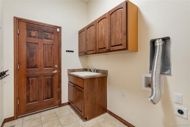 5723 S Union Ct, Littleton, CO 80127 - laundry area with hookup for an electric dryer, cabinet space, light tile patterned floors, and washer hookup