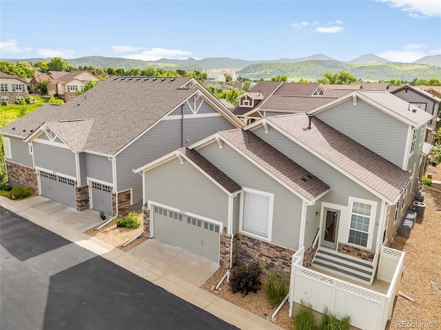 5723 S Union Ct, Littleton, CO 80127 - craftsman-style house with stone siding, a shingled roof, concrete driveway, and an attached garage