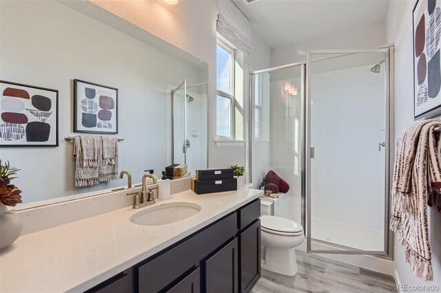14147 Bunny Hop Ln, Parker, CO 80134 - full bathroom with a shower stall, vanity, toilet, and wood finished floors
