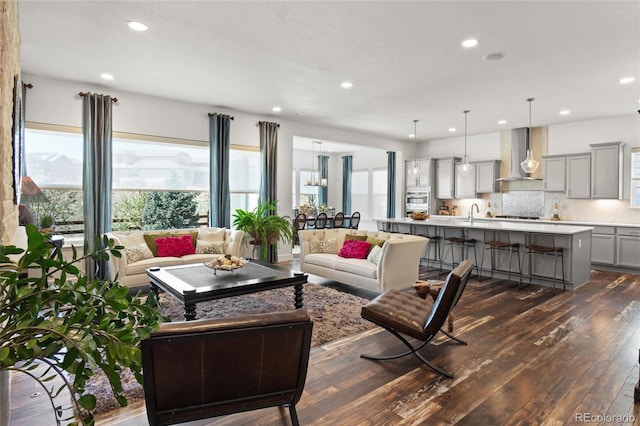 living area with recessed lighting and dark wood-style flooring