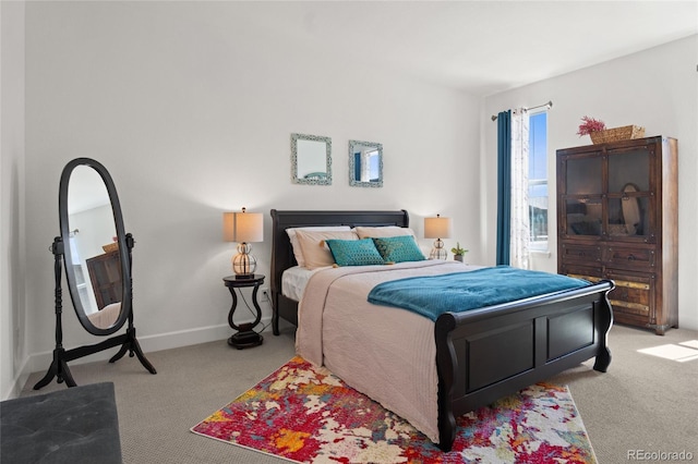 bedroom featuring baseboards and light colored carpet