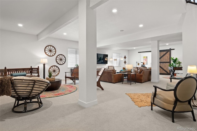 living room with recessed lighting, a barn door, baseboards, and light carpet