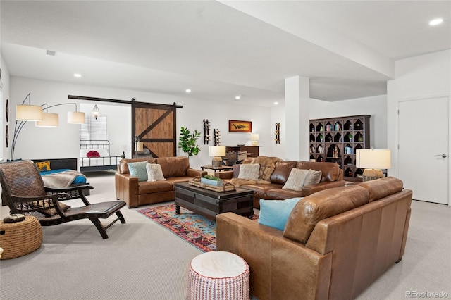 living room with recessed lighting, a barn door, and light carpet