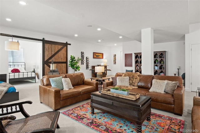 living room featuring light carpet, recessed lighting, and a barn door