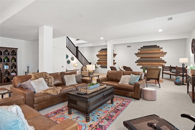 carpeted living room with recessed lighting, visible vents, and stairway