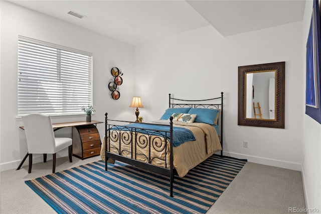 carpeted bedroom with baseboards and visible vents