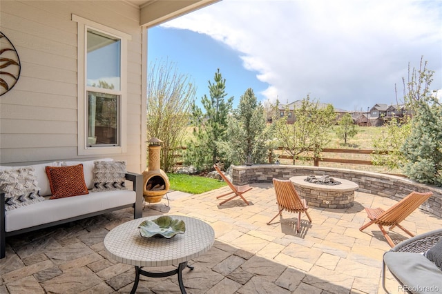 view of patio / terrace with an outdoor living space with a fire pit