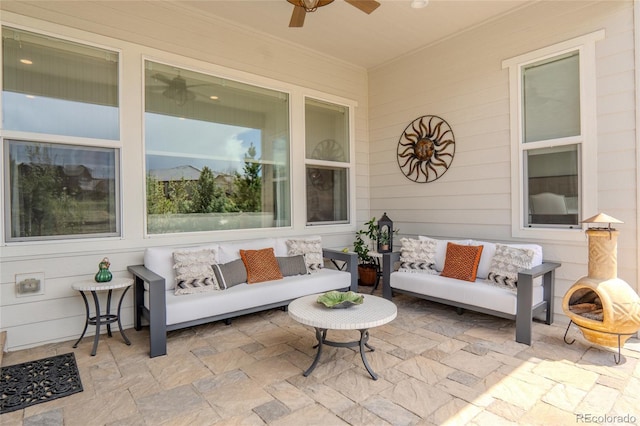 sunroom / solarium featuring ceiling fan and outdoor lounge area