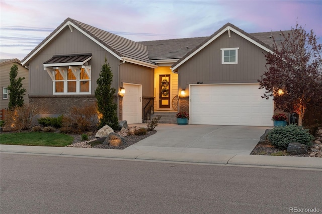 view of front facade featuring brick siding, an attached garage, and concrete driveway