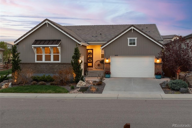 view of front of house featuring concrete driveway, brick siding, and an attached garage