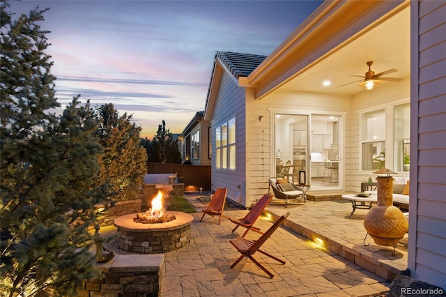 view of patio / terrace featuring a ceiling fan and an outdoor fire pit