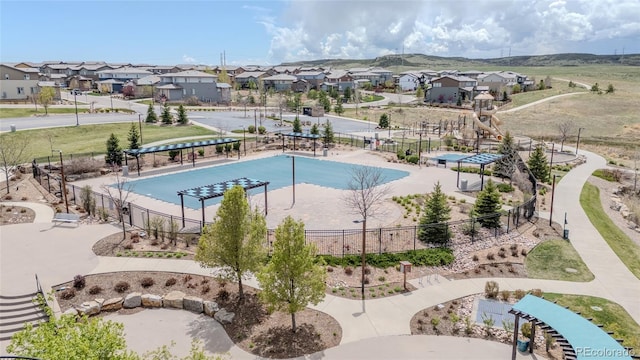 view of swimming pool featuring fence and a residential view