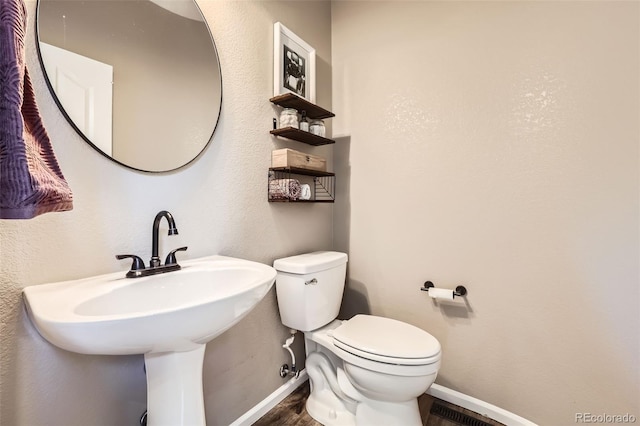 10694 Cedarcrest Cir, Highlands Ranch, CO 80130 - half bathroom with baseboards, wood finished floors, toilet, and a sink
