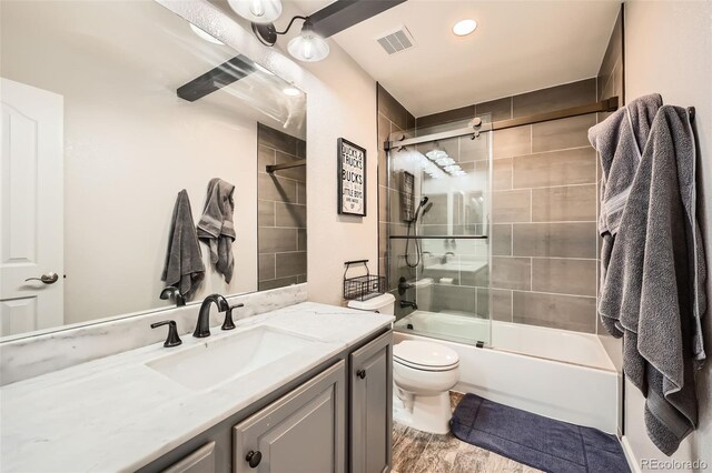 10694 Cedarcrest Cir, Highlands Ranch, CO 80130 - full bathroom featuring vanity, toilet, shower / bath combination with glass door, wood finished floors, and recessed lighting