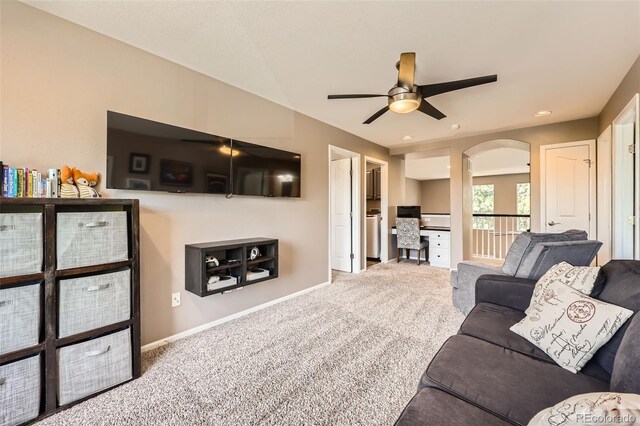 10694 Cedarcrest Cir, Highlands Ranch, CO 80130 - living room featuring ceiling fan, carpet, arched walkways, an office area, and baseboards