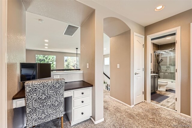 10694 Cedarcrest Cir, Highlands Ranch, CO 80130 - office area featuring carpet flooring, built in desk, recessed lighting, baseboards, and arched walkways