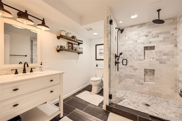 10694 Cedarcrest Cir, Highlands Ranch, CO 80130 - bathroom with a shower stall, vanity, baseboards, toilet, and recessed lighting