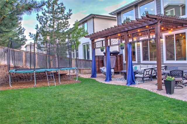 10694 Cedarcrest Cir, Highlands Ranch, CO 80130 - view of yard with a trampoline, a pergola, an outdoor living space, and a patio