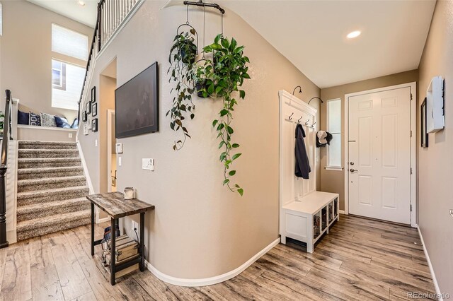 10694 Cedarcrest Cir, Highlands Ranch, CO 80130 - foyer entrance featuring light wood-style floors, stairs, baseboards, and recessed lighting