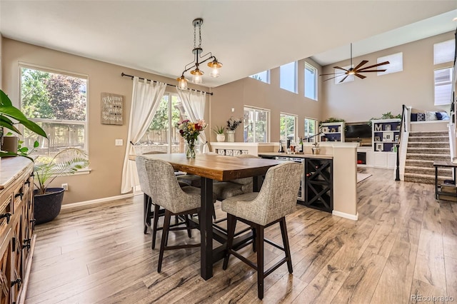 10694 Cedarcrest Cir, Highlands Ranch, CO 80130 - dining space with ceiling fan, light wood-style floors, stairs, and baseboards