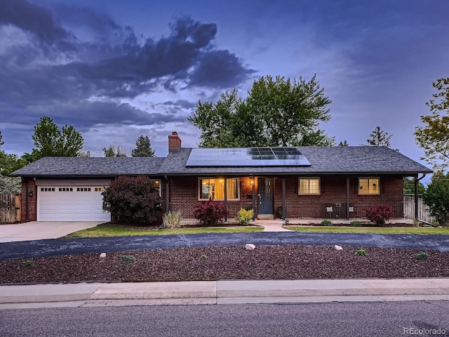 7112 S Platte Canyon Dr, Littleton, CO 80128 - single story home featuring a porch, brick siding, driveway, and a garage