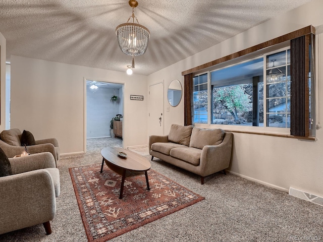 7112 S Platte Canyon Dr, Littleton, CO 80128 - living area featuring carpet, a textured ceiling, a chandelier, and baseboards