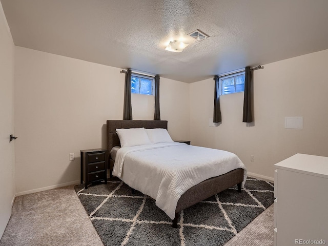 7112 S Platte Canyon Dr, Littleton, CO 80128 - carpeted bedroom featuring baseboards, multiple windows, and a textured ceiling