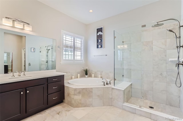 bathroom featuring vanity and separate shower and tub