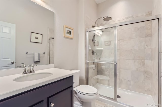 bathroom featuring vanity, an enclosed shower, and toilet