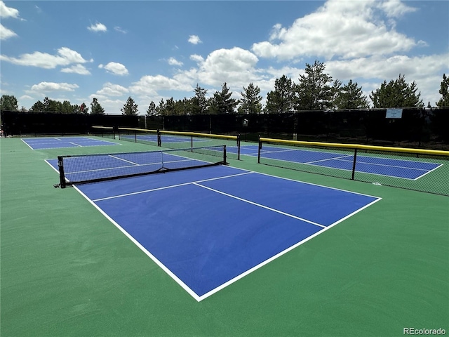 view of tennis court with basketball hoop