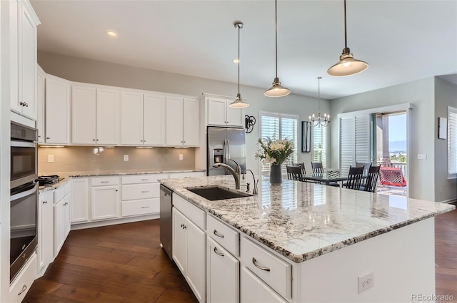 kitchen featuring a center island with sink, white cabinetry, sink, and stainless steel appliances