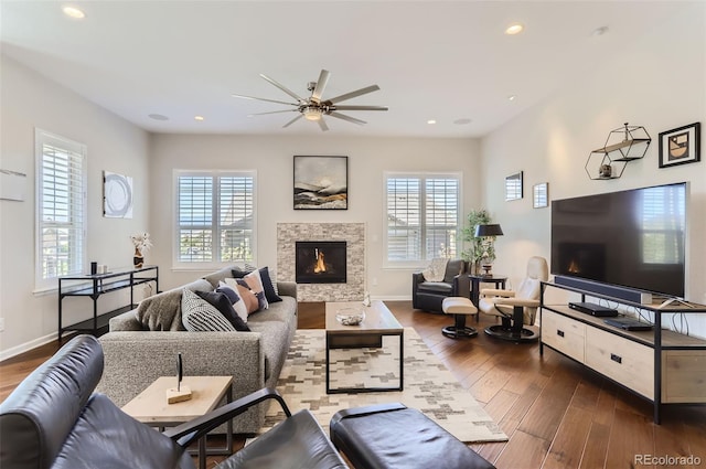 living room featuring ceiling fan and dark hardwood / wood-style floors