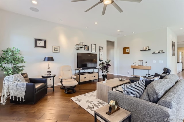 living room featuring ceiling fan and dark hardwood / wood-style flooring