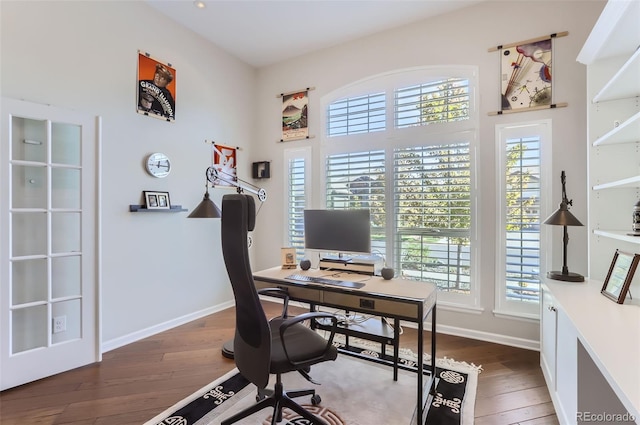 office area with dark hardwood / wood-style floors and a wealth of natural light