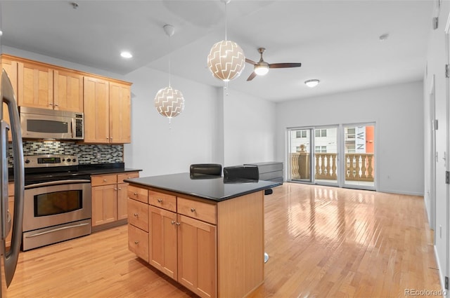 kitchen with dark countertops, tasteful backsplash, light wood finished floors, and stainless steel appliances