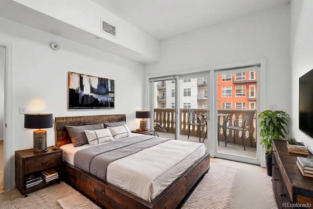 bedroom featuring access to outside, light colored carpet, and visible vents